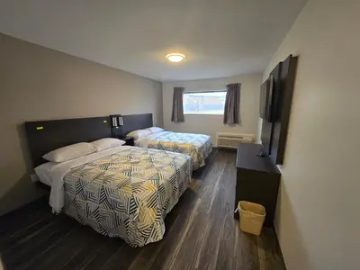 a hotel room with two beds and a flat screen tv at Motel 6 East Windsor, NJ Hightstown in East Windsor