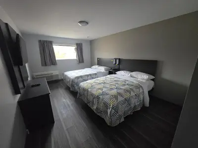 a hotel room with two beds and a desk at Motel 6 East Windsor, NJ Hightstown in East Windsor