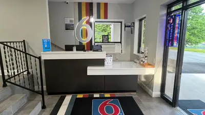 a reception desk with a large olympics sign in a room at Motel 6 East Windsor, NJ Hightstown in East Windsor