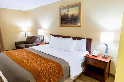 a hotel room with a bed and a chair at Comfort Inn New Holland Amish Country in New Holland