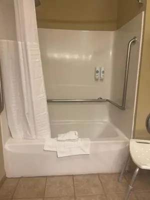 a bathroom with a bath tub with a towel at Comfort Inn New Holland Amish Country in New Holland