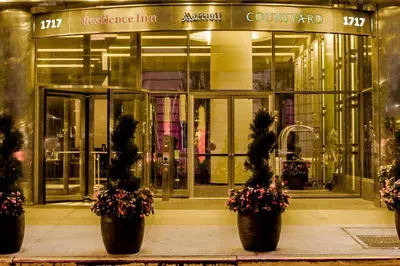 a building with three potted plants in front of it at Residence Inn by Marriott New York Manhattan/Central Park in New York