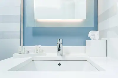 a bathroom with a white sink and a mirror at Residence Inn by Marriott New York Manhattan/Central Park in New York