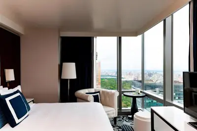 a hotel room with a bed and a large window at Residence Inn by Marriott New York Manhattan/Central Park in New York