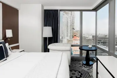 a hotel room with a bed and a large window at Residence Inn by Marriott New York Manhattan/Central Park in New York