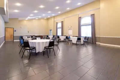 a large room with tables and chairs in it at Days Inn & Suites by Wyndham Cherry Hill - Philadelphia in Cherry Hill
