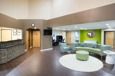 a lobby of a hospital with a couch and chairs at Days Inn & Suites by Wyndham Cherry Hill - Philadelphia in Cherry Hill