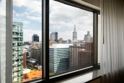 a window with a view of a city skyline at Sheraton Philadelphia Downtown in Philadelphia