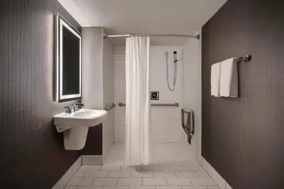 a bathroom with a shower and a sink at Sheraton Philadelphia Downtown in Philadelphia