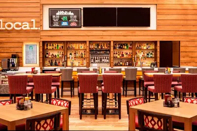 a restaurant with tables and chairs and a bar at Sheraton Philadelphia Downtown in Philadelphia