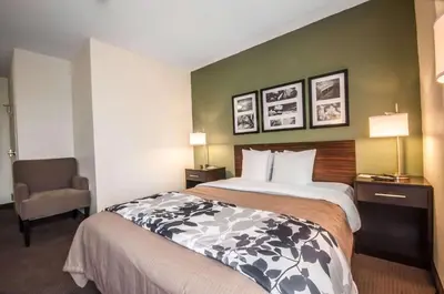 a hotel room with a bed and a chair at Sleep Inn Cinnaminson - Philadelphia East in Cinnaminson