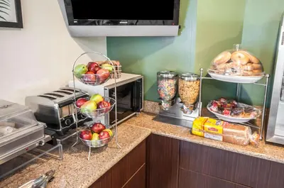 a kitchen counter with baskets of apples and bread at Sleep Inn Cinnaminson - Philadelphia East in Cinnaminson