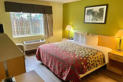 a hotel room with a bed and a window at Super 8 by Wyndham Gloucester in Gloucester City