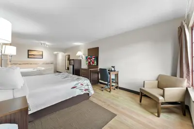 a hotel room with a bed and a desk at Red Roof Inn Lancaster in Lancaster
