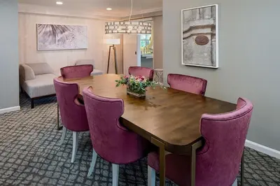 a dining room with a wooden table and purple chairs at The Westin Governor Morris, Morristown in Morristown