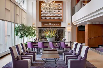 a dining room with a table and purple chairs at The Westin Governor Morris, Morristown in Morristown