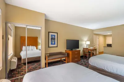 a hotel room with two beds and a flat screen tv at Best Western Harrisburg I-81 Grantville Hershey in Grantville