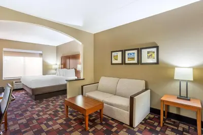 a hotel room with a bed and a couch at Best Western Harrisburg I-81 Grantville Hershey in Grantville