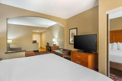 a hotel room with a bed and a flat screen tv at Best Western Harrisburg I-81 Grantville Hershey in Grantville