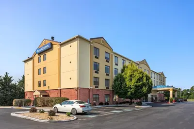 a hotel with a car parked in a parking lot at Best Western Harrisburg I-81 Grantville Hershey in Grantville