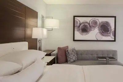 a hotel room with a bed and a couch at The Westin Princeton at Forrestal Village in Princeton