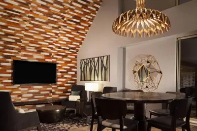 a dining room with a table and a tv at The Westin Princeton at Forrestal Village in Princeton
