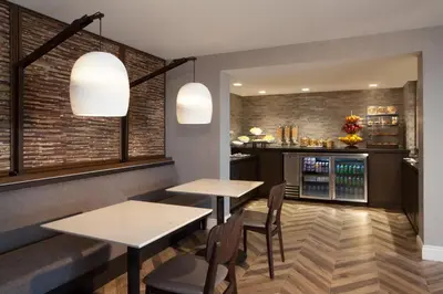 a restaurant with two tables and chairs and a bar at The Westin Princeton at Forrestal Village in Princeton