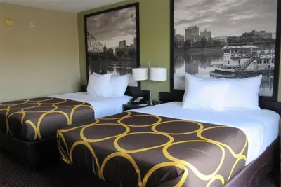 a hotel room with two beds and a large window at Super 8 by Wyndham New Cumberland in New Cumberland
