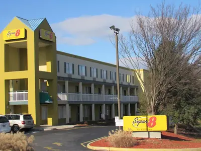 a hotel with a sign in front of a parking lot at Super 8 by Wyndham New Cumberland in New Cumberland