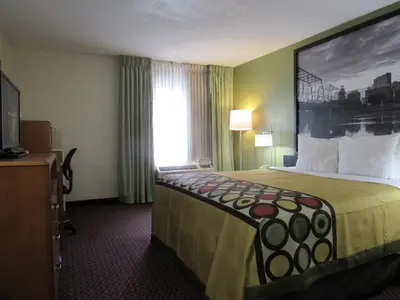 a hotel room with a large bed and a window at Super 8 by Wyndham New Cumberland in New Cumberland