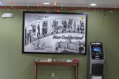 a picture on a wall with a new connecticut at Super 8 by Wyndham New Cumberland in New Cumberland