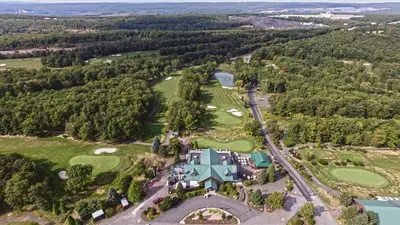 an aerial view of a house with a golf course at Comfort Inn & Suites Barnesville - Frackville in Barnesville