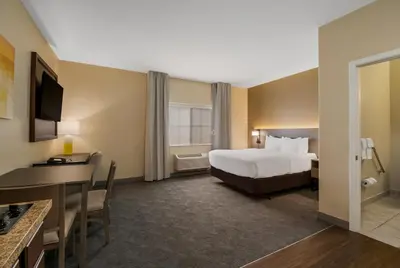 a hotel room with a bed and a desk at Comfort Inn & Suites Barnesville - Frackville in Barnesville