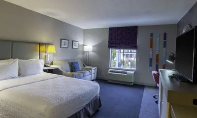 a hotel room with a bed and a television at Hampton Inn East Windsor in East Windsor