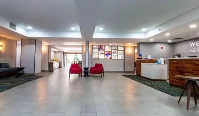 a lobby of a hospital with red chairs and a table at Hampton Inn East Windsor in East Windsor