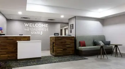 a lobby with a welcome to the garden state sign at Hampton Inn East Windsor in East Windsor