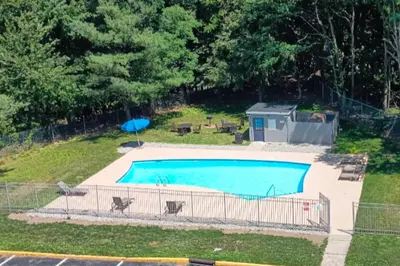 a swimming pool in a yard with a fence at Quality Inn Spring Valley - Nanuet in Spring Valley