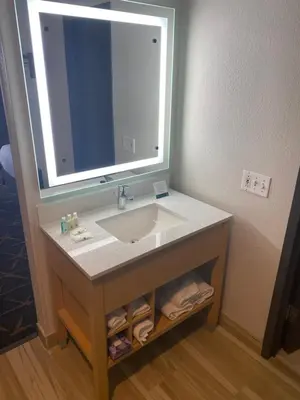 a bathroom sink with a large mirror above it at Quality Inn Spring Valley - Nanuet in Spring Valley
