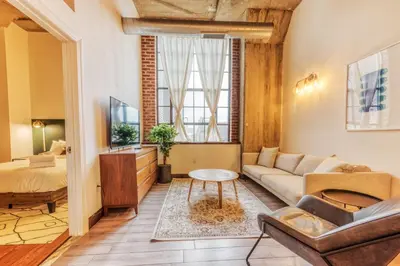 a living room with a couch and a bed at Sosuite at Independence Lofts - Callowhill in Philadelphia