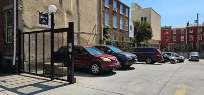 a car parked in front of a gate on a street at Sosuite at Independence Lofts - Callowhill in Philadelphia