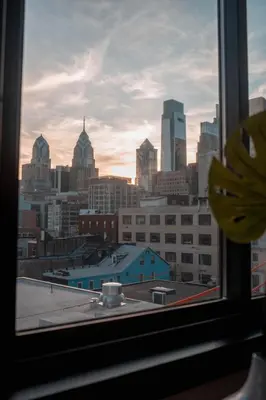 a view of a city skyline from a window at Continental Congress Loft at Kestrel Hotel in Philadelphia