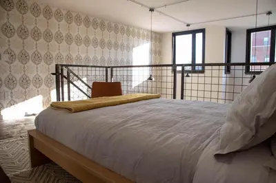 a bedroom with a large bed in a room at Continental Congress Loft at Kestrel Hotel in Philadelphia