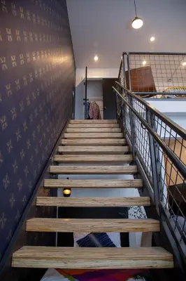 a staircase with wooden steps in a room at Hive Room Loft at Kestrel Hotel in Philadelphia