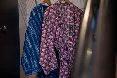 a shirt is hanging on a rack in a closet at Hive Room Loft at Kestrel Hotel in Philadelphia