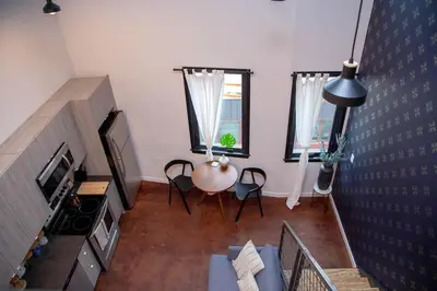 an overhead view of a living room with a table and chairs at Hive Room Loft at Kestrel Hotel in Philadelphia