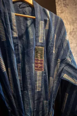 a blue and white shirt hanging on a rack at Mayor's Study Loft at Kestrel Hotel in Philadelphia