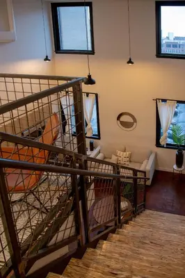 a spiral staircase in a living room with a couch at Viaduct Loft at Kestrel Hotel in Philadelphia