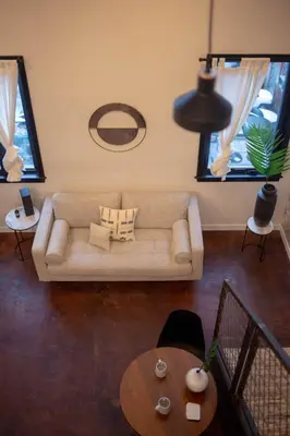 a living room with a couch and a table at Viaduct Loft at Kestrel Hotel in Philadelphia