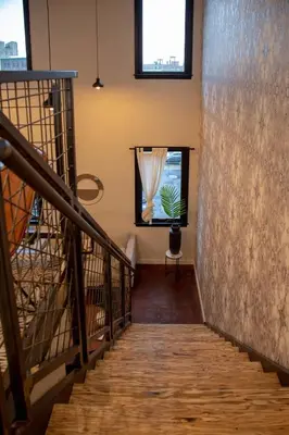 a staircase in a building with a window at Viaduct Loft at Kestrel Hotel in Philadelphia