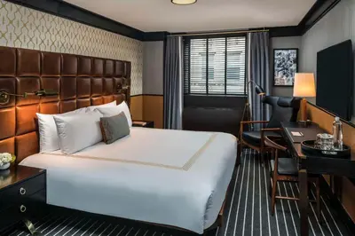 a hotel room with a bed and a desk at Gild Hall, A Thompson Hotel, by Hyatt in New York